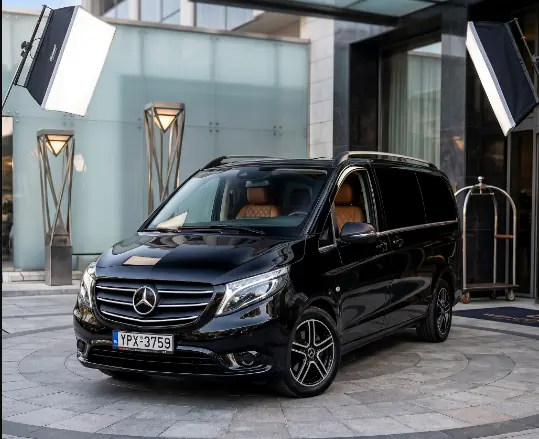 Black Mercedes Vito parked in front of a luxury Athens hotel entrance