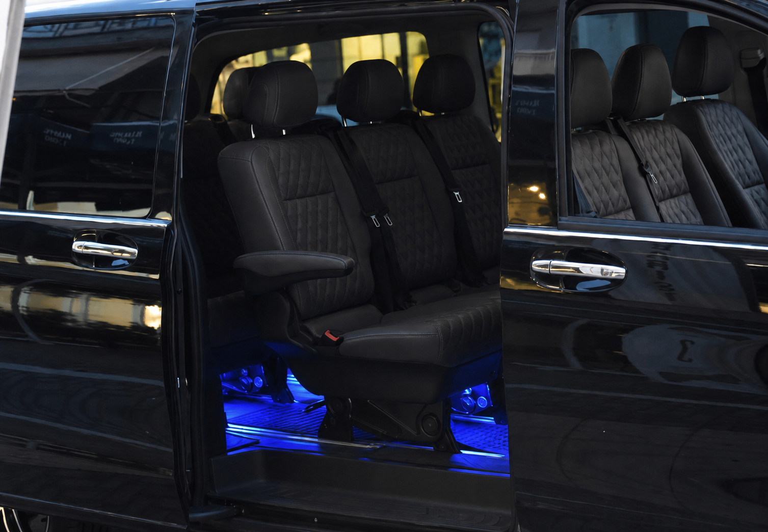Mercedes V Class interior with diamond-stitched black leather seats and blue ambient floor lighting